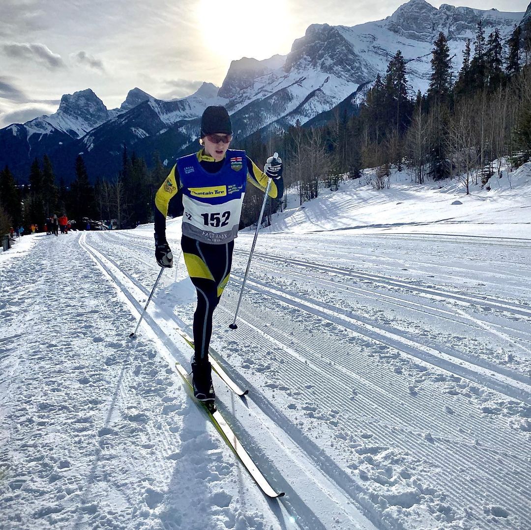 cross-country skier racing on snowy course